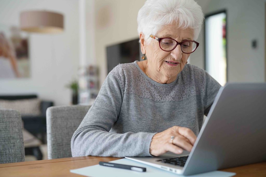 bigstock-Old-woman-at-home-using-laptop-213583483