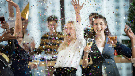office celebrating with drinks and confetti