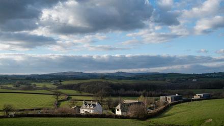 green hills with houses in devon
