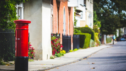 red post box on a rural street
