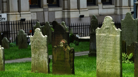 A group of stone headstones in a grassy area