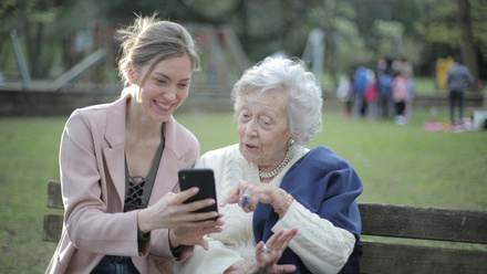 young lady showing phone to old lady.jpg