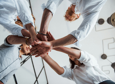 team huddle with hands
