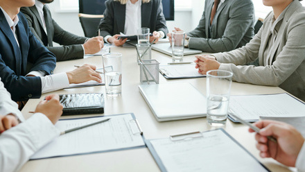 sitting around table in boardroom having a discussion