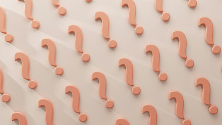 a large group of peach coloured question marks