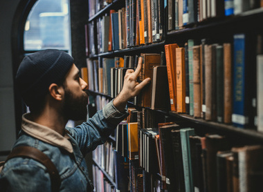 resource library man picking a book